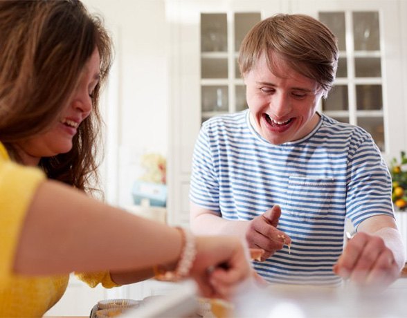 A special needs man smiling at home