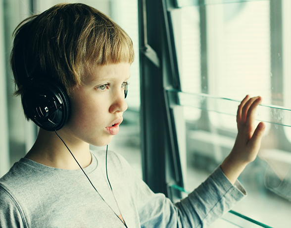 young boy with autism wearing headphones 