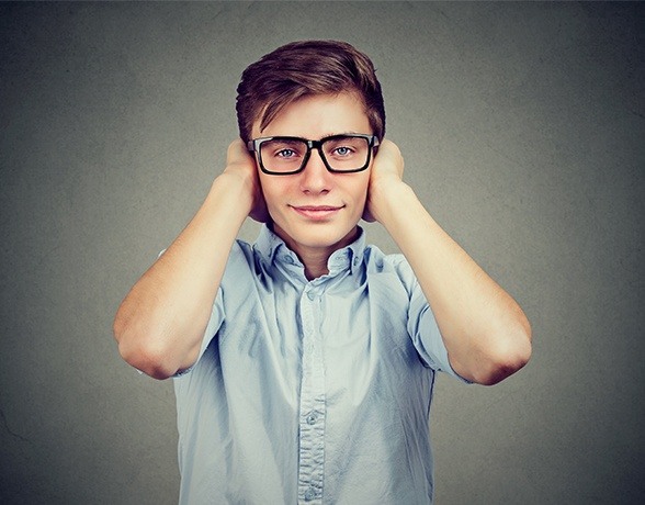 young boy with autism wearing headphones 
