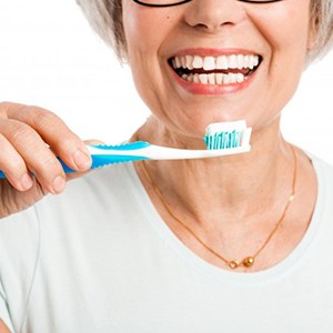a woman smiling before brushing her teeth
