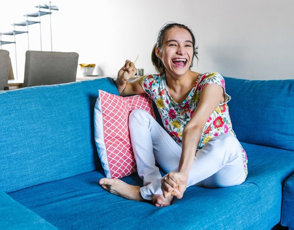 a woman smiling and laughing with new dentures