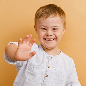 young child with Down syndrome smiling 