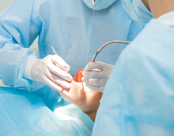 Close-up of performing oral surgery for dental emergency in Grand Prairie, TX
