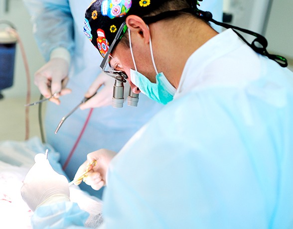 Dentist performing minor oral surgery