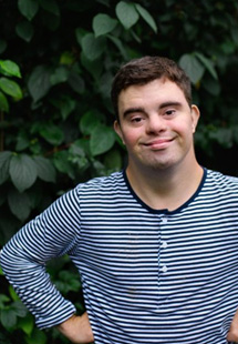 a special needs person posing and smiling