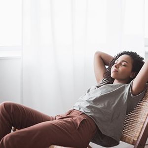 a woman sitting back and resting after a dental visit