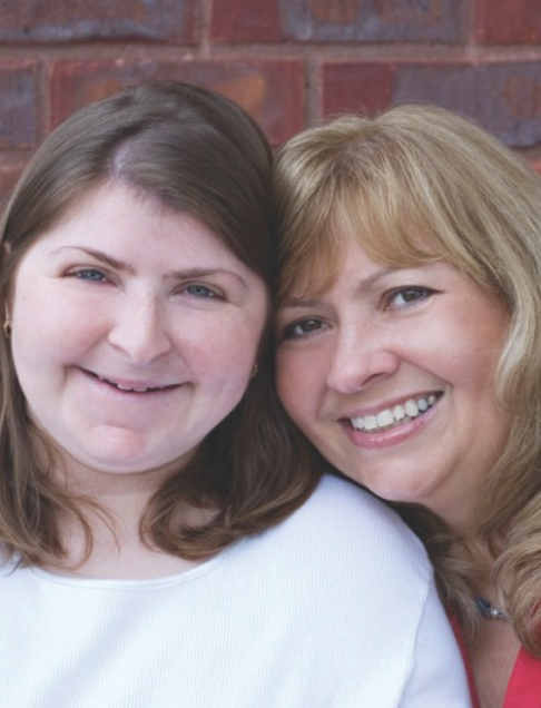 Two women smiling after receiving dental services