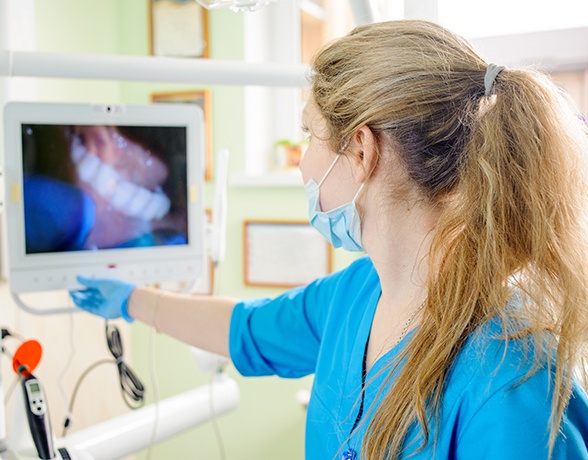 Dental team member looking at images capture with intraoral camera