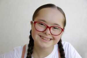 young girl with Down syndrome smiling