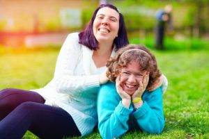 two young women with special needs smiling 