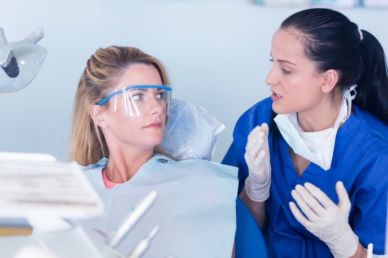 patient speaking to dentist about mental health effects on smiles