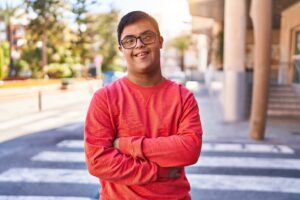 Man with Down syndrome wearing a red shirt and smiling